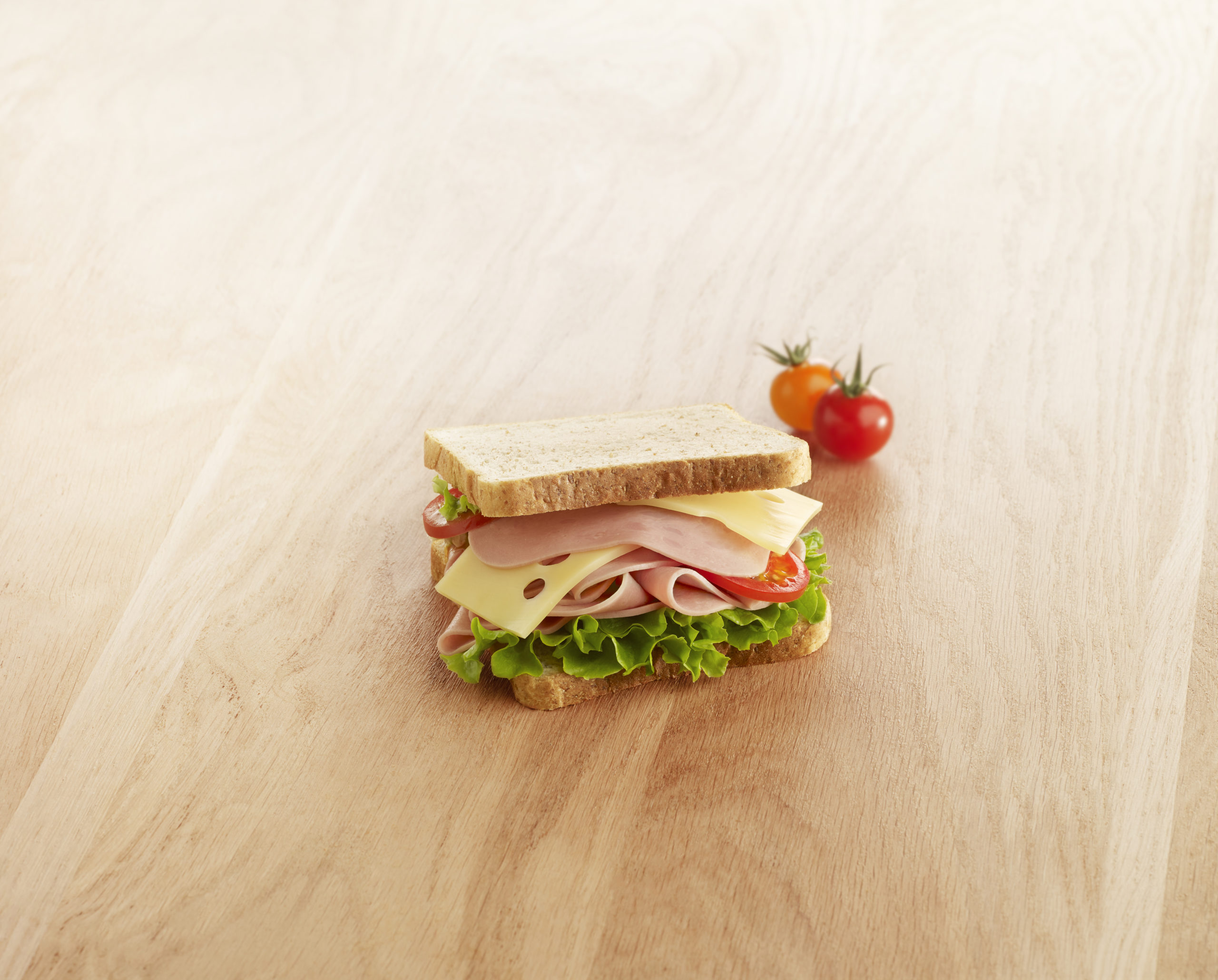 Visuel Sandwich halal jambon dinde avec tomate cerise sur planche en bois